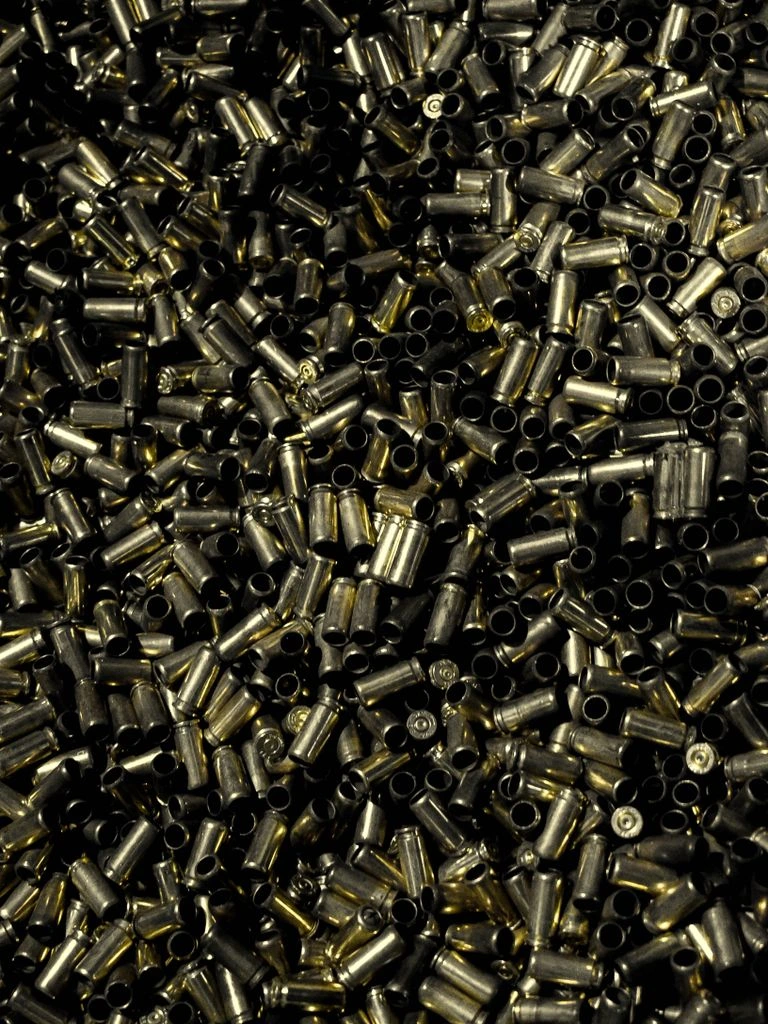 Safety razors and shaving brush on slate surface.