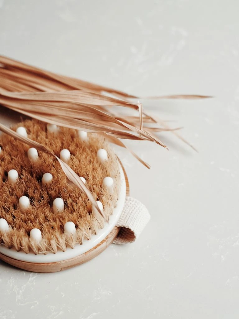 Beard brush with wooden handle on leather